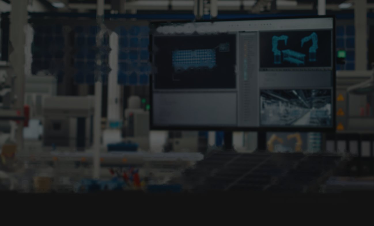 Engineering control room with monitors showing factory telemetry, production floor out of focus