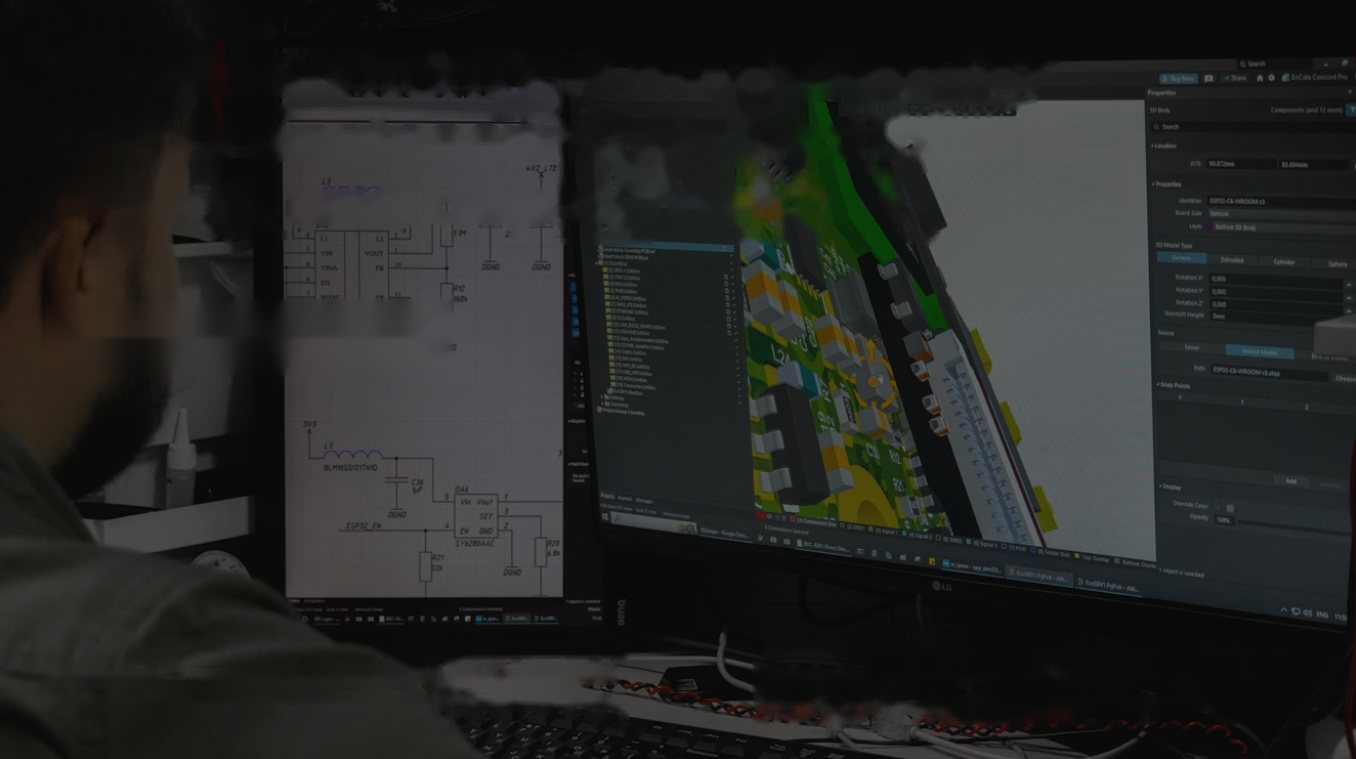 Engineer reviewing a circuit schematic and a 3D model on two monitors